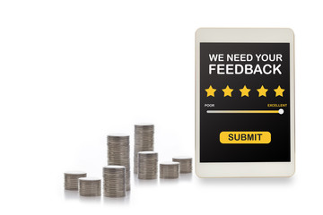 Rating application review on computer tablet screen with stack of coins. Five stars feedback concept and business success technology idea