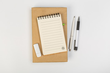 stack of colorful notebooks with pen isolated on white background