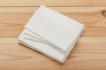 white paper napkin or tissue on the wooden table background.