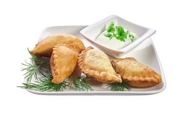 Chebureks on a white plate isolated on a white background