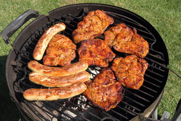 various meat and sausages on the charcoal grill