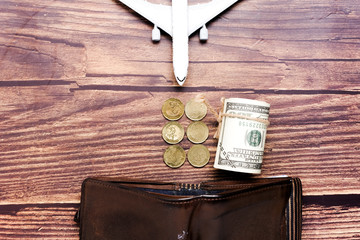 Toy plane, money and wallet. Travel ban concept can save money more.