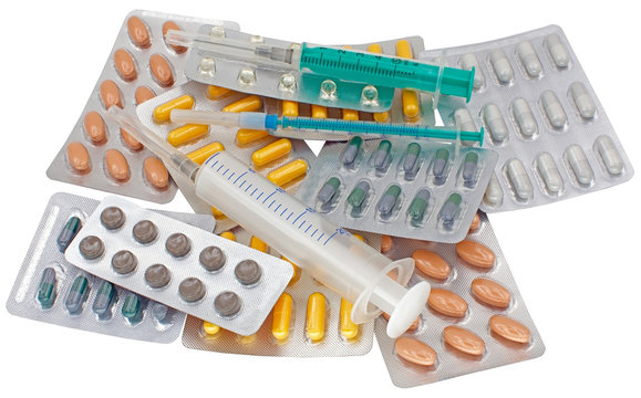 medical pack of pills and syringe on white
