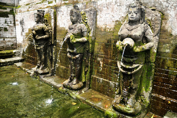Bathing temple figures or holy water fountain of Goa Gajah or Elephant Cave significant Hindu archaeological site for travelers people travel visit and respect at Ubud city town in Bali, Indonesia