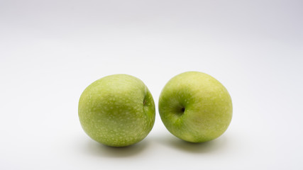 Real Green Apple isolated on white background attached with clipping path