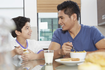 Father and son eating cereals