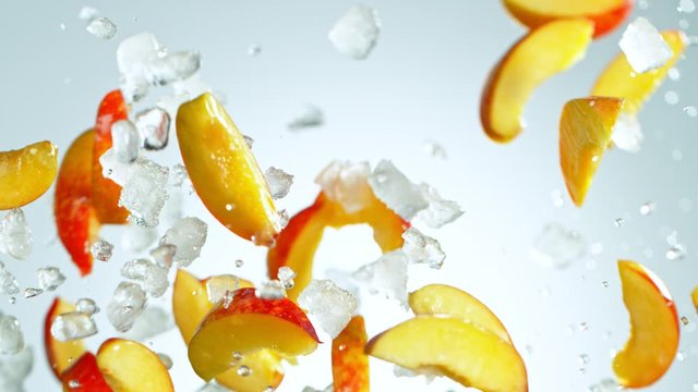 Super Slow Motion Shot of Flying Fresh Peach Slices and Crushed Ice at 1000 fps.