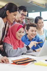 Students studying together in library