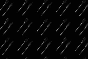black fork and black knife on black background pattern vertical