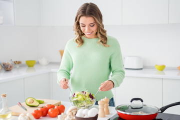 Portrait of her she nice attractive charming focused cheerful cheery wavy-haired girl making domestic delicious lunch hobby workshop in modern light white kitchen house indoors