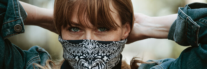 Woman covering her mouth with a bandana during coronavirus outbreak