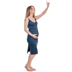 Fototapeta premium Pregnant woman in dress standing looking smiling pointing showing on white background isolation