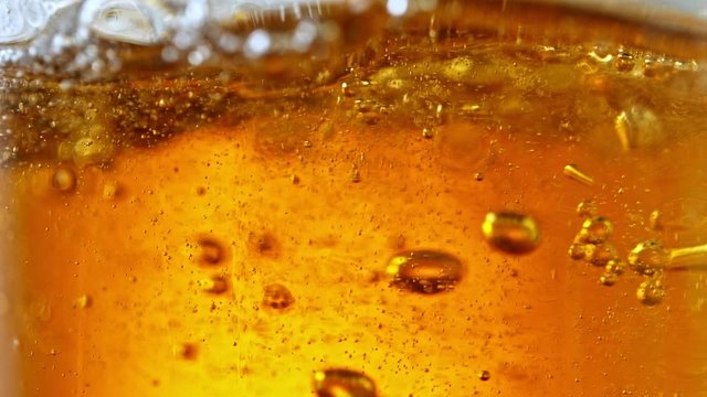 Super Slow Motion Detail Shot of Beer Bubbles in Glass at 1000fps.