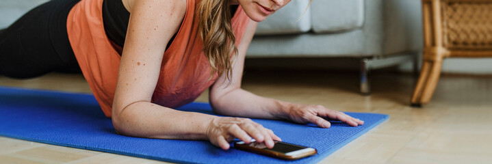 Woman working out at home during coronavirus pandemic