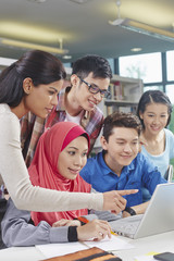 Students studying together in library