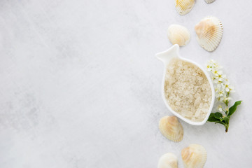 Concept of Spa-cosmetic and cosmetic procedures. Spa-sea salt in white dishes and seashells on...