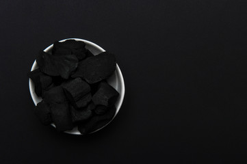 Natural wood charcoal, traditional charcoal or hard wood charcoal on black color background. Zero waste