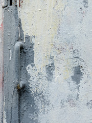 Fragment of an old iron door with a handle painted in gray paint. Drips of dried oil paint on a metal surface. Grunge pattern.