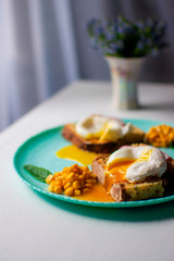 the yolk flows from the egg.
corn and eggs on a turquoise plate. 