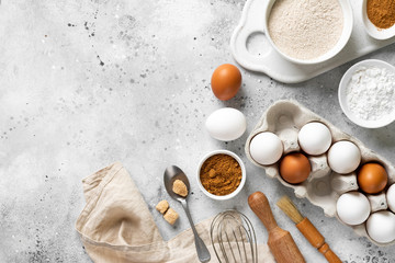 Ingredients for baking on a culinary background. Eggs, flour, cinnamon, sugar, soda on the kitchen table. Concept of preparation for baking. Top view with space for text