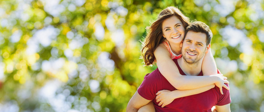 Happy couple in the park on a sunny day having fun