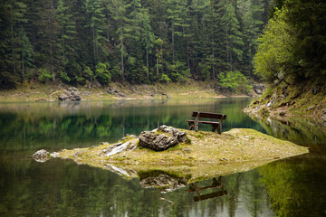 green lake - grüner see in austria with bench on island