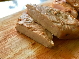 Grilled pork chops, Fried marinated pork steak on wooden background. Top view.