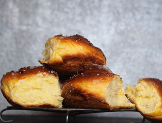Homemade cake.The view on top of buns ,sprinkle with sesame seeds and sugar syrup on the dark table.
