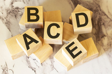 Letters of the alphabet on wooden blocks and a light background