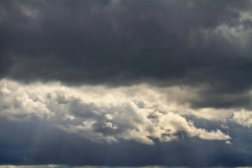 Naklejka na ściany i meble Cloudscape. Blue sky and grey clouds. Sunny day. Cumulus clouds.