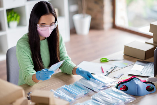Photo of chinese busy lady family business organizing packing face flu medical masks global spreading donating poor countries prepare sets for delivery home office quarantine indoors