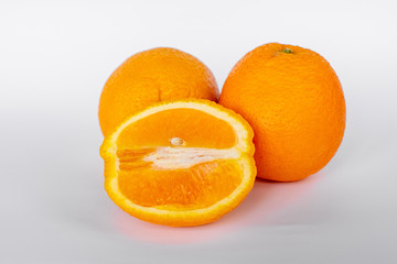 Whole orange fruit and his segments or cantles isolated on white background cutout