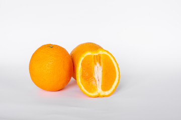 Whole orange fruit and his segments or cantles isolated on white background cutout