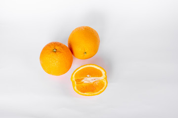 Whole orange fruit and his segments or cantles isolated on white background cutout