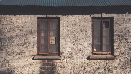 Brick walls with two glass wooden windows