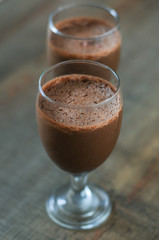 Chocolate foam dessert on wooden table.
