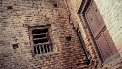 Fototapeta na wymiar Brick walls with wooden window with holes