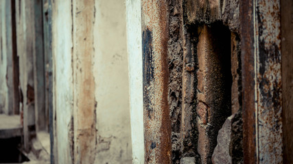 Broken worn out wall with brown wood