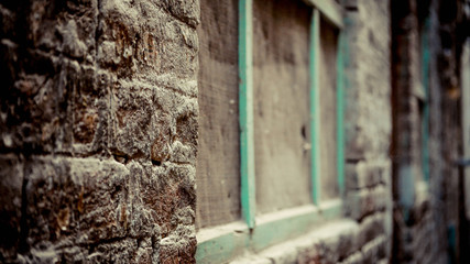 Fototapeta na wymiar Brow brick wall with wooden green frame of window