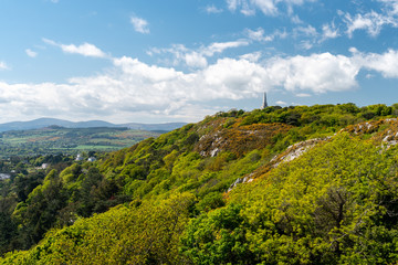 Fototapeta na wymiar Scenic Irish hill landscape on a summer day as seen from Dalkey Hill, Dublin, Ireland with the iconic Killiney Obelisk in the distance,