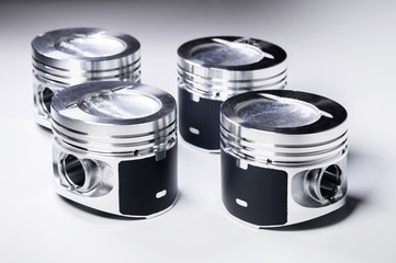 New parts for the internal combustion engine. Pistons on a gray gradient background