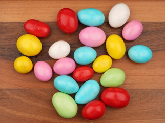 Colorful almond dragee on wooden background