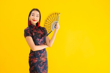 Portrait beautiful young asian woman wear chinese dress with fan