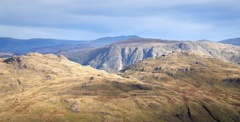 Views of Langdale Pikes and Pavey Ark from Prison Band below Swirl How on a sunny day in the Lake District.