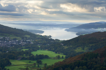 Fototapeta na wymiar Lake Windermere and Ambleside set amongst the green pastures and mountains of the Lake District.