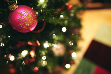 A christmas bauble on a Christmas tree with a blurred background