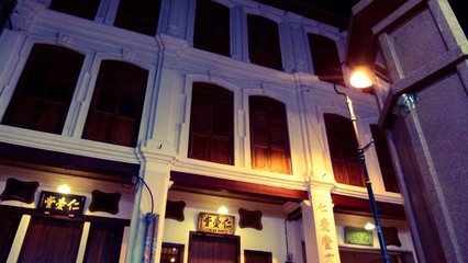 Night time of a white building with wooden windows
