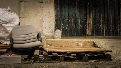 Old broken office chair on wooden platform