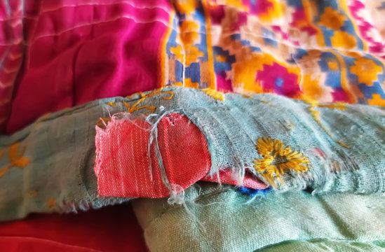 close up of a colorful quilt made from patches of cloths and sarees