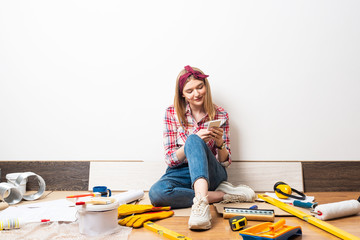Dreamy girl using smartphone at home